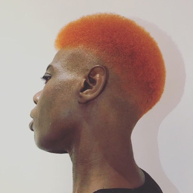 Close-cropped hair coloured bright copper